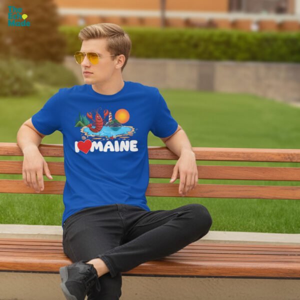 Man wearing I Love Maine lobster graphic t-shirt in royal blue on park bench